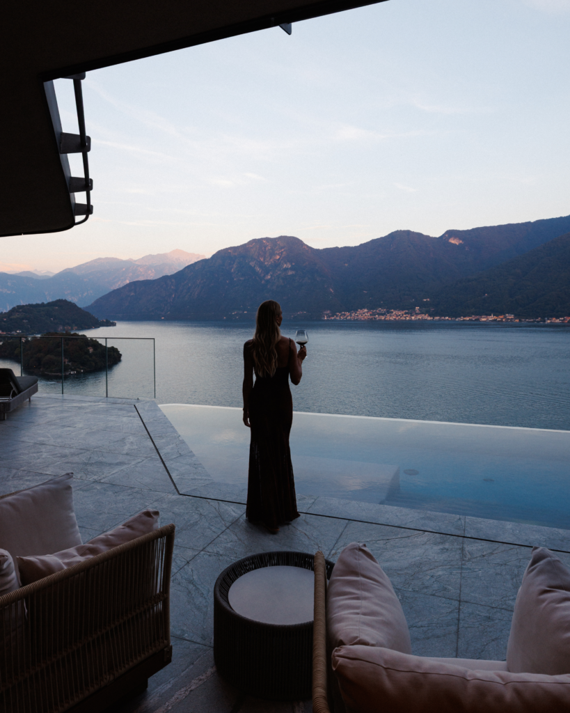 Woman enjoying sunset views over Lake Como at Villa Osee